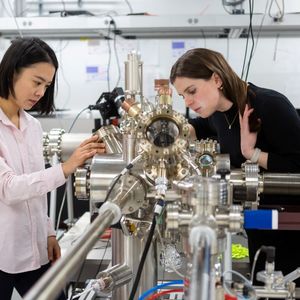 Asst. Prof. Sarah King (right) and a student working with a photoemission electron microscope. (Nancy Wong)